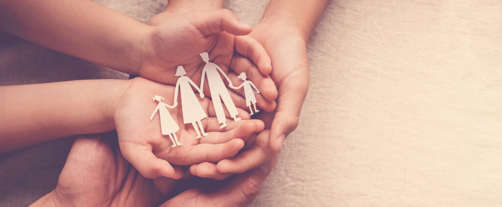 Family Lawyers in Langley British Columbia portrayed by hands holding a paper family cutout 